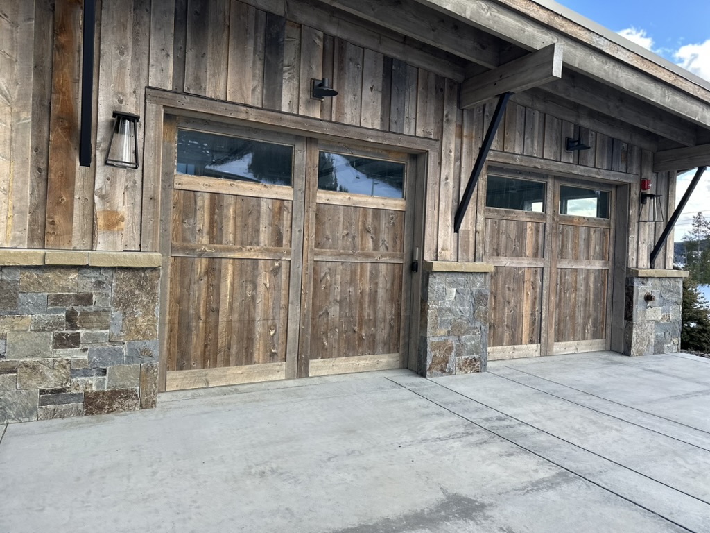 Luxury Montana home exterior painting with stone and wood siding - Big Sky Painting project in Bozeman MT