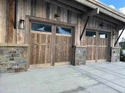 Luxury Montana home exterior painting with stone and wood siding - Big Sky Painting project in Bozeman MT