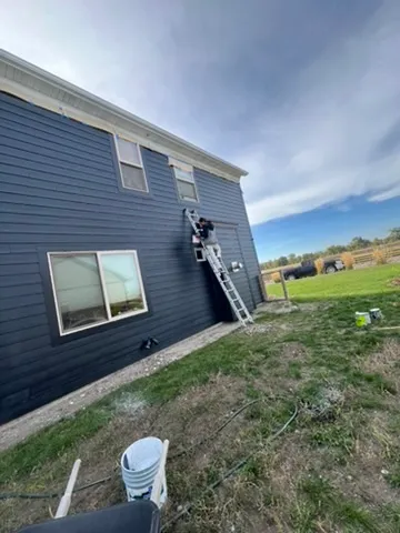 Bridger Canyon home before exterior painting - faded and weather-damaged siding