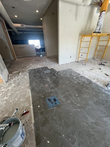 Professional garage door painting with protective covering - Bozeman MT residential project