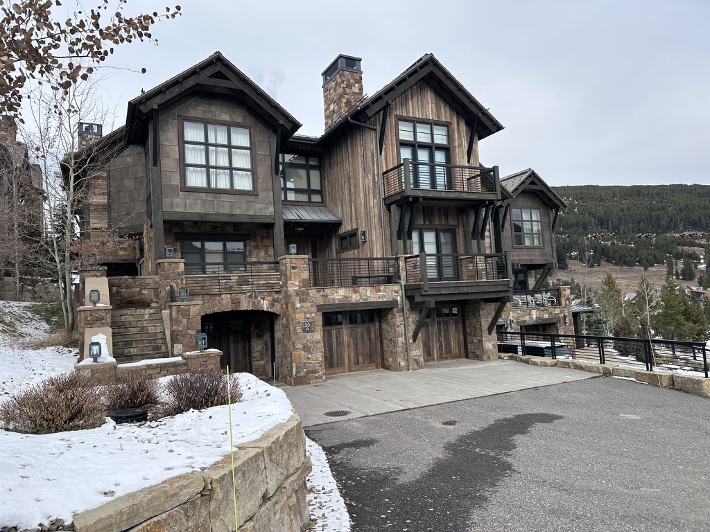 High-end mountain home exterior painting with winter landscape - Big Sky Montana luxury property